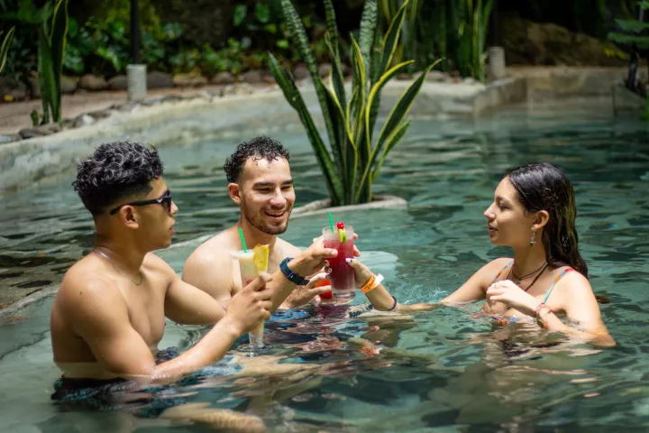 a group of people swimming in a pool of water