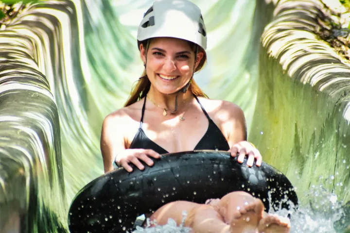 a young girl riding a wave on a surfboard in the water