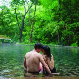 a couple sitting in natural hot springs