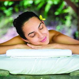a girl laying down on a massage table