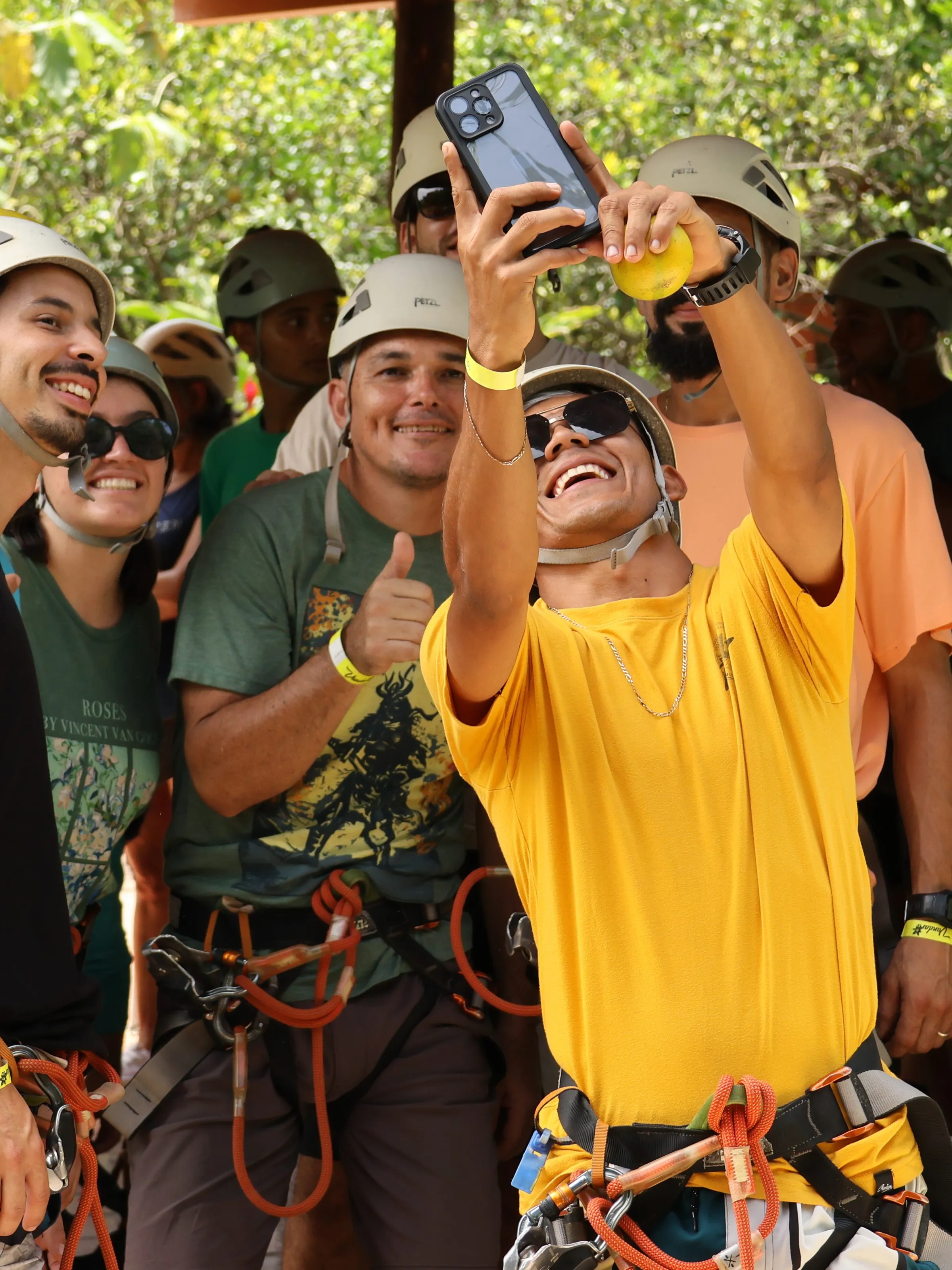 Group of people in helmets taking a selfie outdoors.