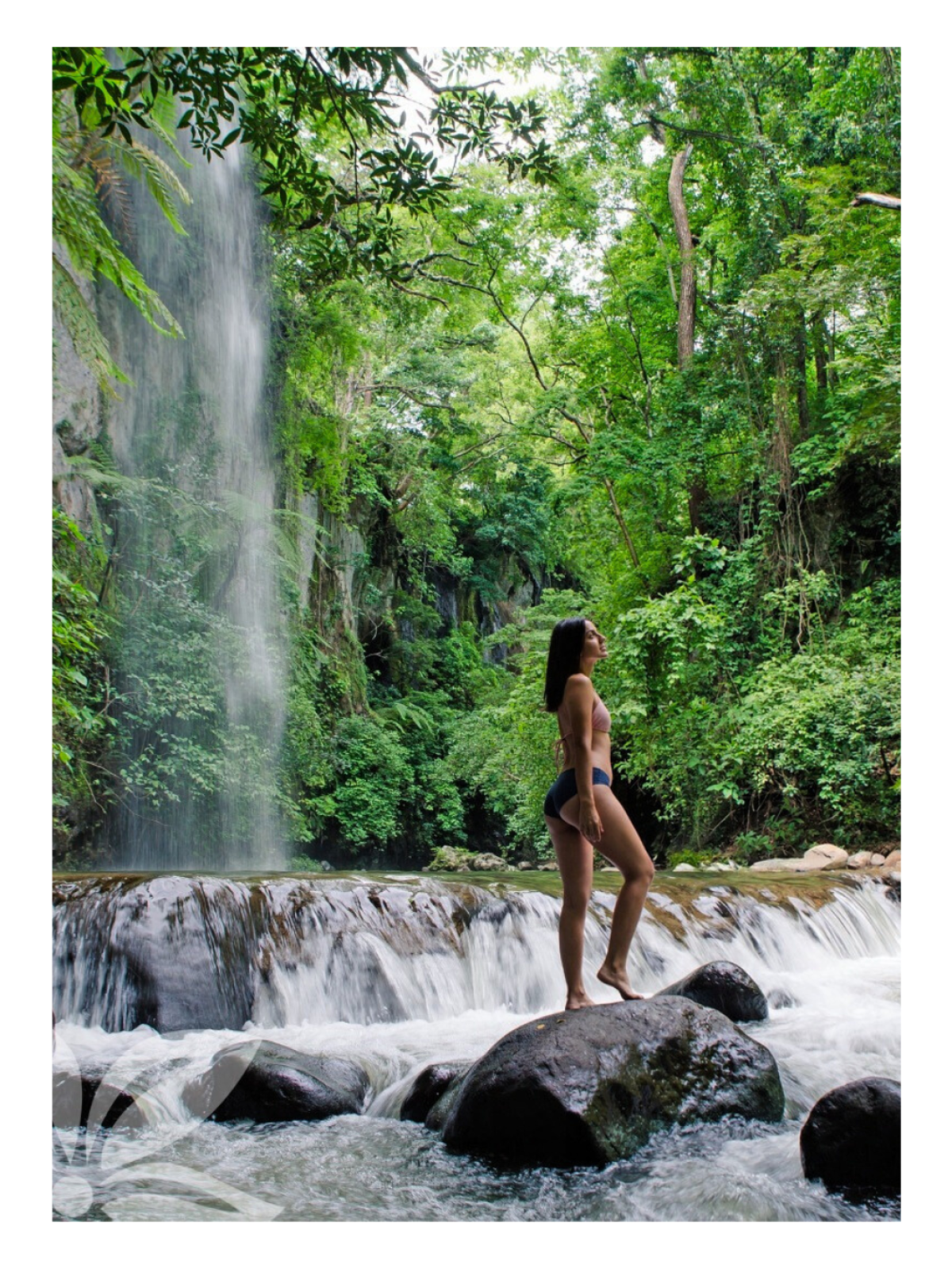 a man standing next to a waterfall