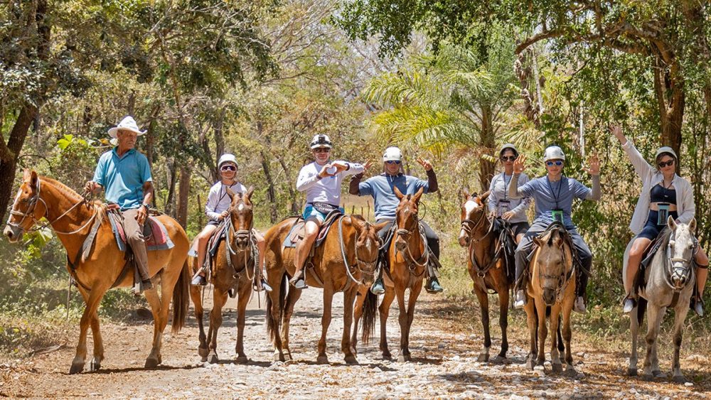 a group of people riding on the back of a horse